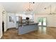 Spacious open kitchen with wood floors, a gray kitchen island, and modern appliances at 4115 Tansel Rd, Indianapolis, IN 46234
