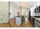 Bright kitchen with granite counters, gray cabinets, a stone accent wall, and stainless steel appliances at 4115 Tansel Rd, Indianapolis, IN 46234