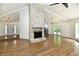Open-concept living area with stone fireplace and a view into the kitchen, with sleek finishes at 4115 Tansel Rd, Indianapolis, IN 46234