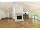 Open-concept living space with stone fireplace and view of the modern kitchen at 4115 Tansel Rd, Indianapolis, IN 46234
