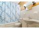 Cozy bathroom with tiled walls, classic fixtures, and a shower featuring a decorative curtain at 414 S Green St, Brownsburg, IN 46112