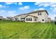 Large, grassy backyard with black fence, featuring a covered patio and view of the home's exterior at 4250 Blackford Rd, Bargersville, IN 46106