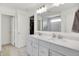 Modern bathroom with double vanity, white cabinets, quartz countertop, and a large mirror reflecting the shower at 4250 Blackford Rd, Bargersville, IN 46106