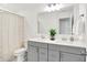 Bathroom with double sink vanity, framed mirror, shower with tan patterned curtain at 4250 Blackford Rd, Bargersville, IN 46106