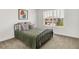 Bright bedroom featuring a metal frame bed with a quilted comforter, a large window, and simple decor at 4250 Blackford Rd, Bargersville, IN 46106
