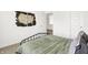 Cozy bedroom features a unique, rustic wood art piece above the bed and neutral-colored carpet at 4250 Blackford Rd, Bargersville, IN 46106