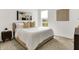 Bright bedroom featuring a comfortable bed, modern art, a window overlooking green space, and a sleek nightstand at 4250 Blackford Rd, Bargersville, IN 46106