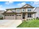 Charming two-story home with a three-car garage, beautiful brick accents, and a well-manicured lawn under a bright blue sky at 4250 Blackford Rd, Bargersville, IN 46106