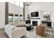 Bright, open living room with a fireplace, modern chandelier, and comfortable seating, perfect for relaxation at 4250 Blackford Rd, Bargersville, IN 46106