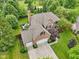 Aerial view showcases a brick home, spacious lot, mature trees and an expansive driveway and backyard at 427 Quincy Pl, Westfield, IN 46074