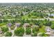 Wide aerial shows a residential neighborhood with tree-lined streets, well-maintained lawns, and access to nearby amenities at 427 Quincy Pl, Westfield, IN 46074