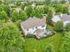 Aerial view of a backyard featuring a stone patio with outdoor seating and a well-maintained lawn at 427 Quincy Pl, Westfield, IN 46074