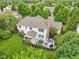 Aerial view of a large backyard showcasing a stone patio with outdoor seating, a grill, and landscaped beds at 427 Quincy Pl, Westfield, IN 46074