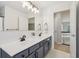 Bright bathroom with dual sink vanity, modern fixtures, and access to the upstairs hallway at 427 Quincy Pl, Westfield, IN 46074