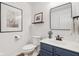 Updated bathroom featuring blue vanity, modern fixtures, framed artwork, and new toilet at 427 Quincy Pl, Westfield, IN 46074