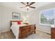 Cozy bedroom features a wooden sleigh bed, ceiling fan, neutral walls, and natural light at 427 Quincy Pl, Westfield, IN 46074