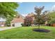 Brick home with a three car garage and an expansive, well-maintained lawn at 427 Quincy Pl, Westfield, IN 46074