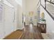 Grand foyer featuring soaring ceilings, hardwood floors, staircase and an elegant console table at 427 Quincy Pl, Westfield, IN 46074