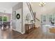 Inviting foyer featuring hardwood floors, a staircase and a console table with decor at 427 Quincy Pl, Westfield, IN 46074