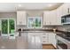 Bright open kitchen with white cabinets, granite counters and stainless appliances at 427 Quincy Pl, Westfield, IN 46074