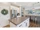 Bright open kitchen boasts stainless appliances, white cabinetry, and a large center island at 427 Quincy Pl, Westfield, IN 46074