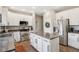 Bright kitchen boasts stainless appliances, center island, granite counters, and white cabinets at 427 Quincy Pl, Westfield, IN 46074