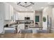 Modern kitchen with white cabinets, stainless steel appliances, and a center island with bar seating at 427 Quincy Pl, Westfield, IN 46074