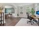 Bright office space features natural light, dark floors, and adjacent formal dining room at 427 Quincy Pl, Westfield, IN 46074