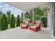 Covered patio area features chairs with lush landscaping, creating a relaxing outdoor space at 427 Quincy Pl, Westfield, IN 46074