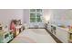 Bright playroom with built-in storage and a whimsical rainbow rug at 427 Quincy Pl, Westfield, IN 46074