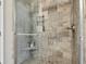 Beautifully tiled shower with a glass enclosure and built in shelf and bench at 427 Quincy Pl, Westfield, IN 46074