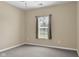Neutral bedroom featuring a window with blinds and grey carpet flooring at 4295 Washington Blvd, Plainfield, IN 46168