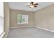 Neutral bedroom featuring a large window and grey carpet flooring at 4295 Washington Blvd, Plainfield, IN 46168