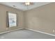 A cozy bedroom featuring neutral carpet, neutral paint, and a window with blinds at 4295 Washington Blvd, Plainfield, IN 46168