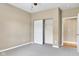 Neutral bedroom featuring a closet with bi-fold doors and grey carpet flooring at 4295 Washington Blvd, Plainfield, IN 46168
