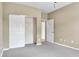 Neutral bedroom featuring a closet with sliding doors and grey carpet flooring at 4295 Washington Blvd, Plainfield, IN 46168