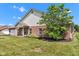 Brick home side view with green lawn and landscaping at 4295 Washington Blvd, Plainfield, IN 46168