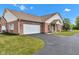 Beautiful brick home featuring an attached two car garage and manicured lawn at 4295 Washington Blvd, Plainfield, IN 46168