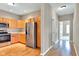 The well-lit kitchen has stainless steel appliances, wood cabinets, and hardwood floors at 4295 Washington Blvd, Plainfield, IN 46168