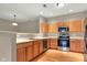 Modern kitchen features stainless steel appliances, wooden cabinets, and hardwood floors at 4295 Washington Blvd, Plainfield, IN 46168