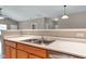 A close-up of a stainless steel double sink with a white countertop and light wood cabinets in the kitchen at 4295 Washington Blvd, Plainfield, IN 46168