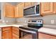 Close up on stainless appliances in kitchen and wooden cabinets at 4295 Washington Blvd, Plainfield, IN 46168