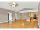 Bright living room with hardwood floors, ceiling fan, and an open layout to the kitchen at 4295 Washington Blvd, Plainfield, IN 46168