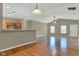 Open-concept living room with hardwood floors, neutral paint, fan, and connects seamlessly to the kitchen at 4295 Washington Blvd, Plainfield, IN 46168