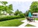Lush backyard featuring a fire pit, pond access, and an outdoor dining area perfect for entertaining guests at 4380 Dunsany Ct, Indianapolis, IN 46254