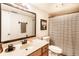 Bathroom featuring a single sink vanity, a toilet, framed mirror, and a shower/tub combo with a striped curtain at 4380 Dunsany Ct, Indianapolis, IN 46254