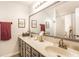 Well lit bathroom featuring double vanity, modern mirrors, and shower with decorative floral curtain at 4380 Dunsany Ct, Indianapolis, IN 46254