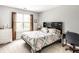 Relaxing secondary bedroom features a comfortable bed with patterned bedding and natural light at 4380 Dunsany Ct, Indianapolis, IN 46254