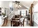 Open concept dining room with vaulted ceilings, a chandelier, and views of the staircase and living area at 4380 Dunsany Ct, Indianapolis, IN 46254