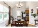 Inviting dining room with a chandelier, hardwood floors, and a large window providing plenty of natural light at 4380 Dunsany Ct, Indianapolis, IN 46254